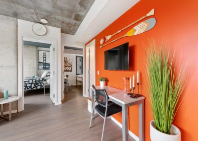 Luxury furnished apartment featuring an orange accent wall and double bedrooms.